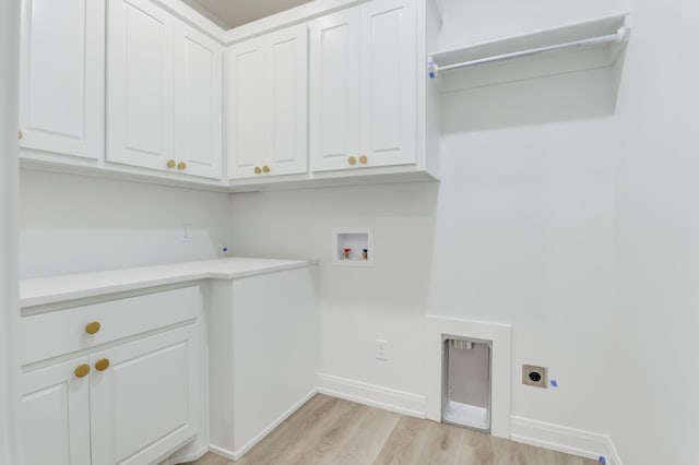 laundry room with cabinets, electric dryer hookup, washer hookup, and light hardwood / wood-style floors