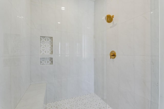 bathroom with a tile shower