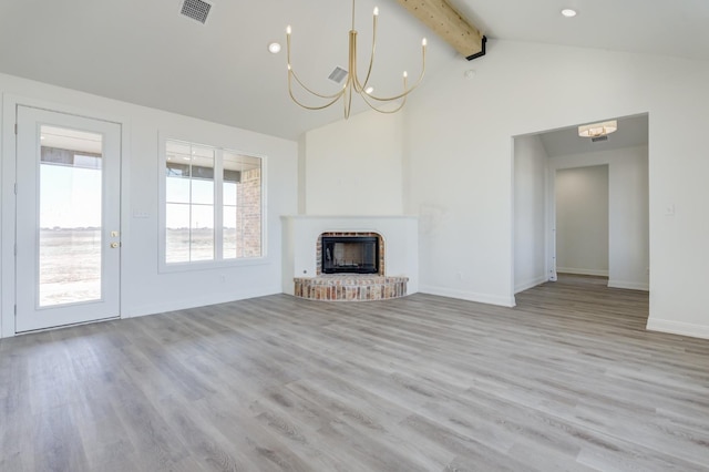 unfurnished living room featuring high vaulted ceiling, a fireplace, light wood-type flooring, a chandelier, and beam ceiling