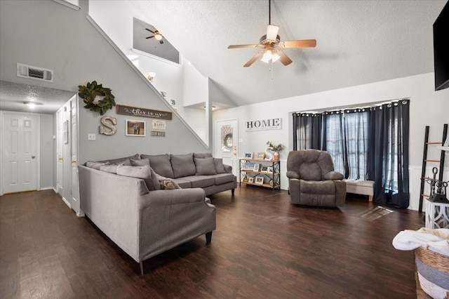 living room with ceiling fan, dark wood-type flooring, and a textured ceiling