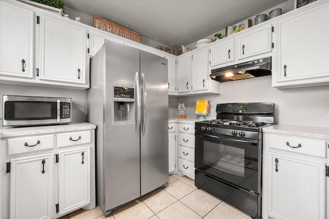 kitchen with white cabinetry, stainless steel appliances, a textured ceiling, and light tile patterned floors