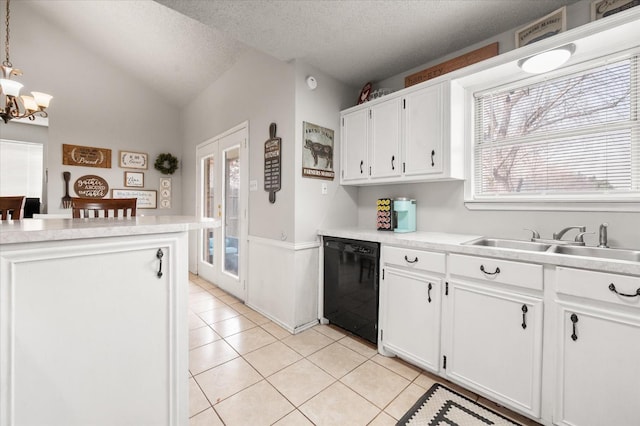 kitchen featuring pendant lighting, white cabinets, a textured ceiling, and dishwasher