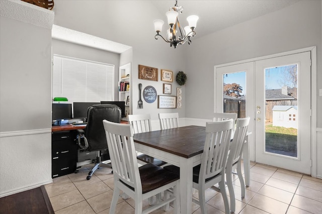 tiled dining area featuring a wealth of natural light, a notable chandelier, and french doors