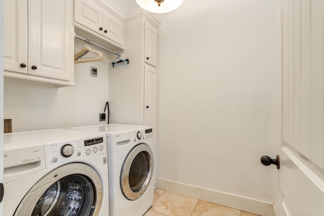 laundry area with cabinets, washer and dryer, and light tile patterned floors