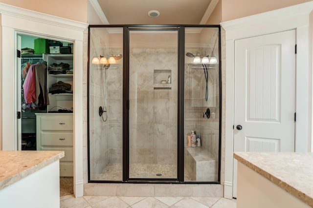 bathroom featuring vanity, crown molding, and a shower with shower door