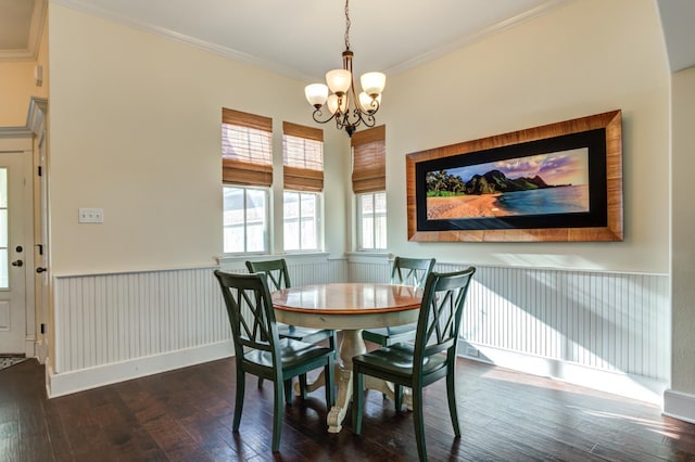 dining space with crown molding, dark hardwood / wood-style floors, and a chandelier