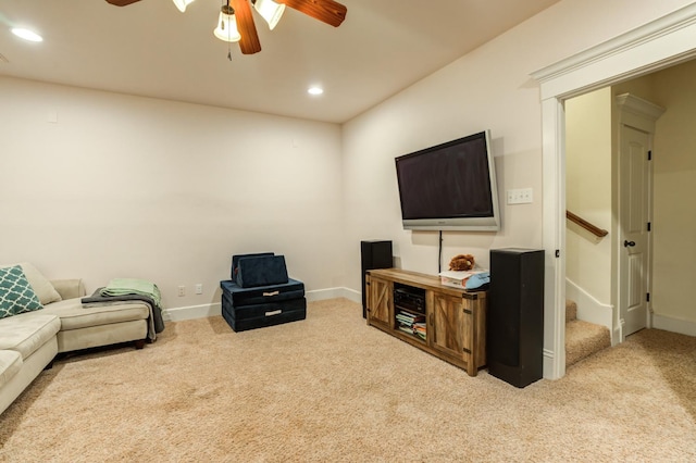 carpeted living room with ceiling fan