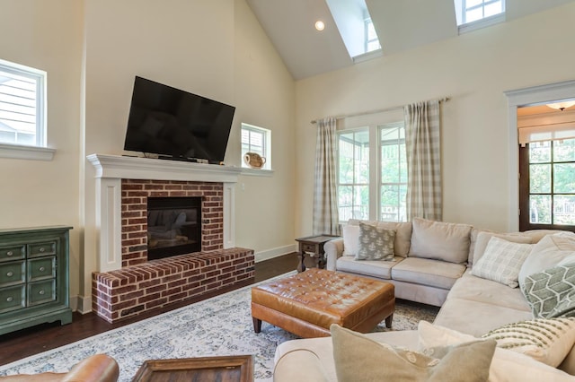 living room featuring dark hardwood / wood-style floors, high vaulted ceiling, and a brick fireplace