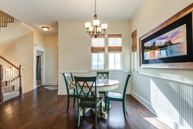 dining space featuring ornamental molding, dark wood-type flooring, and a chandelier