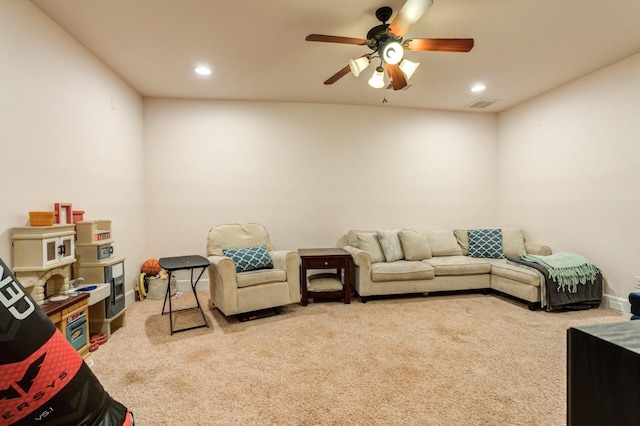 carpeted living room featuring ceiling fan