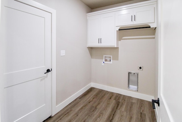 clothes washing area with light wood finished floors, cabinet space, washer hookup, electric dryer hookup, and baseboards