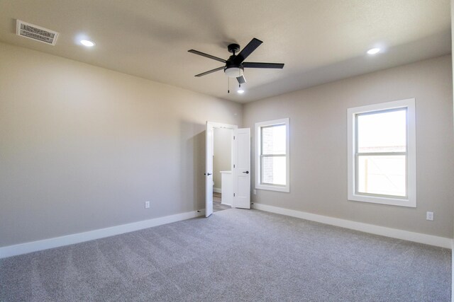 spare room with recessed lighting, carpet flooring, baseboards, visible vents, and a ceiling fan