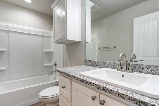 full bathroom featuring vanity, bathing tub / shower combination, and toilet