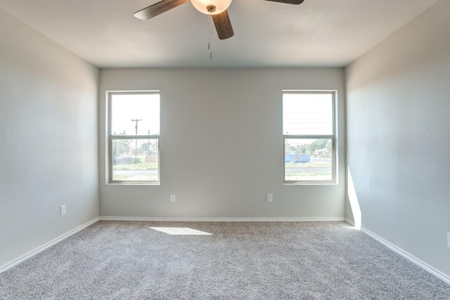 carpeted empty room featuring ceiling fan