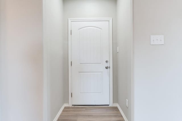 doorway to outside with light wood-type flooring