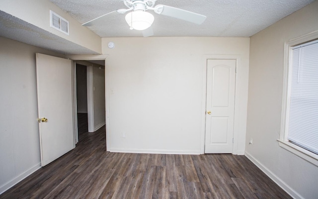 interior space with ceiling fan, a textured ceiling, and dark hardwood / wood-style flooring