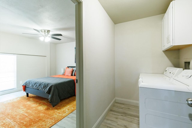 laundry room featuring cabinets, washing machine and dryer, ceiling fan, and light wood-type flooring