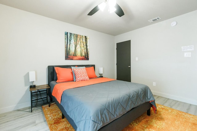 bedroom with light hardwood / wood-style floors and ceiling fan