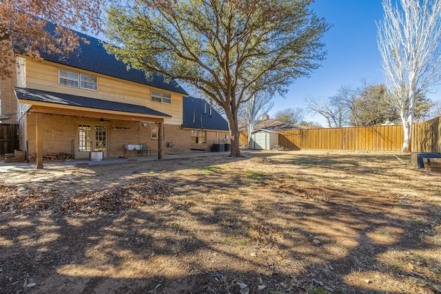 view of yard featuring a patio area and a storage shed