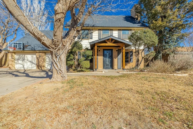 view of front of property with a garage and a front lawn