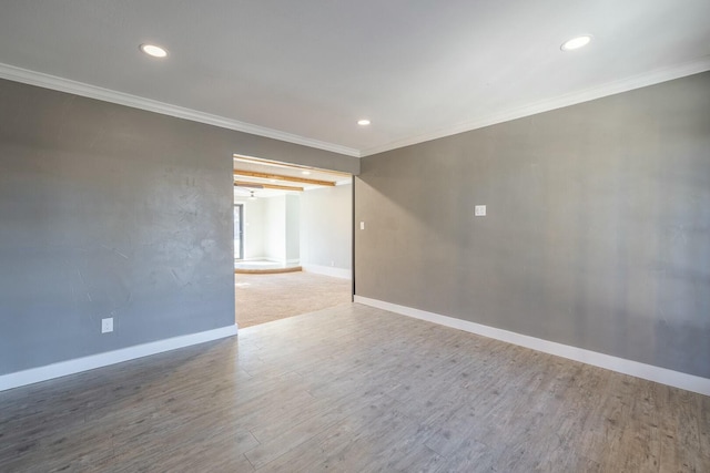 empty room with wood-type flooring and ornamental molding