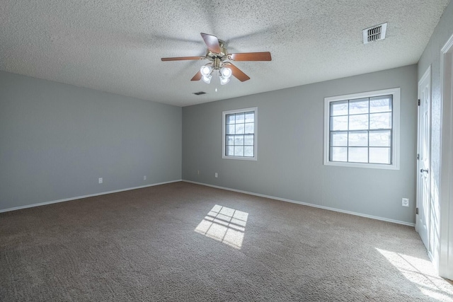 spare room with carpet, a textured ceiling, and ceiling fan