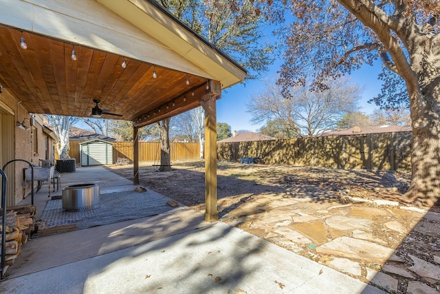 view of patio / terrace with ceiling fan, a storage unit, and central AC unit