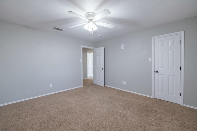 carpeted spare room with ceiling fan