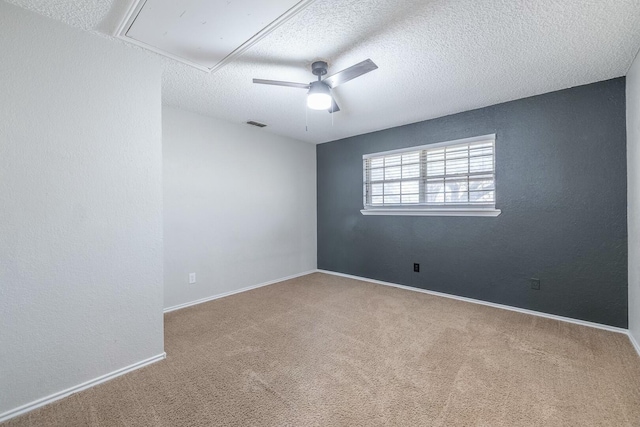 carpeted empty room featuring a textured ceiling