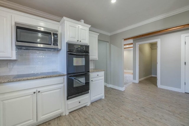 kitchen featuring crown molding, black appliances, light hardwood / wood-style floors, decorative backsplash, and white cabinets