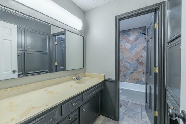 bathroom featuring vanity, a textured ceiling, tile patterned floors, and toilet