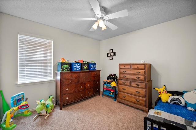 bedroom with ceiling fan, light colored carpet, and a textured ceiling