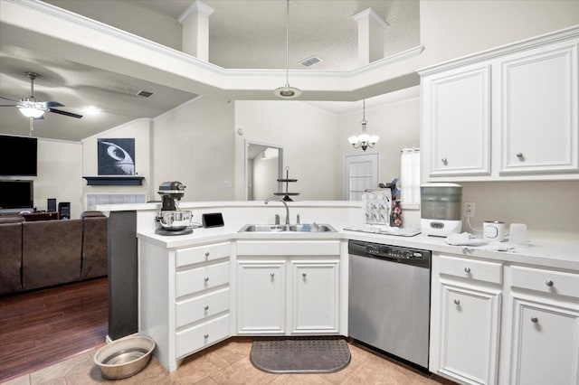 kitchen featuring pendant lighting, stainless steel dishwasher, sink, and white cabinets