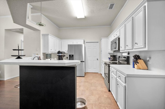 kitchen featuring white cabinetry, a breakfast bar area, ornamental molding, and appliances with stainless steel finishes