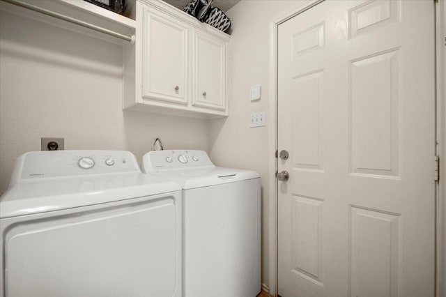 washroom with cabinets and separate washer and dryer