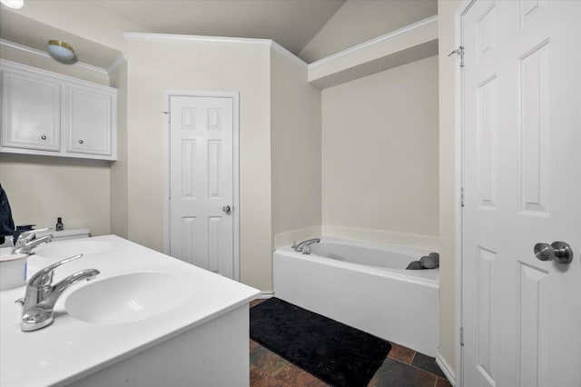 bathroom with vanity, lofted ceiling, and a washtub