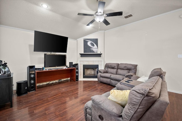 living room with dark wood-type flooring, lofted ceiling, ornamental molding, and a textured ceiling