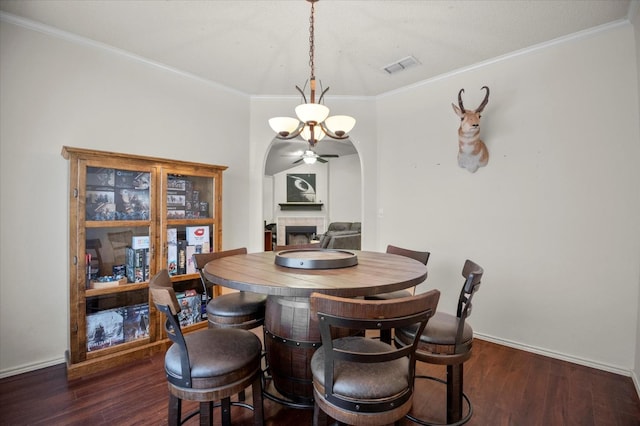 dining room with dark hardwood / wood-style flooring and ornamental molding