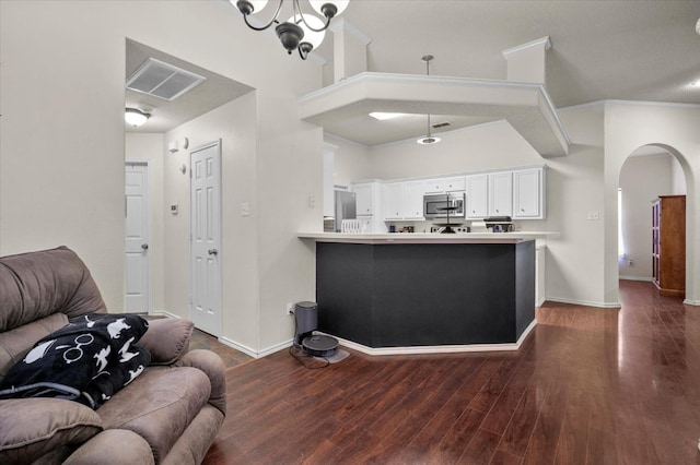 kitchen featuring white cabinetry, dark hardwood / wood-style flooring, and kitchen peninsula