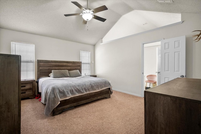 carpeted bedroom featuring ceiling fan, lofted ceiling, and a textured ceiling