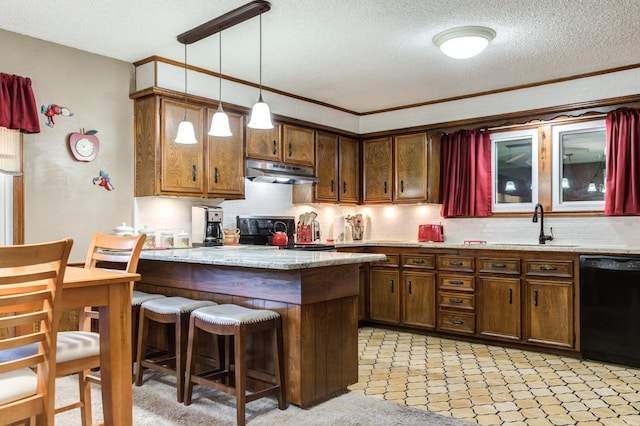 kitchen featuring sink, decorative light fixtures, a kitchen breakfast bar, black dishwasher, and kitchen peninsula