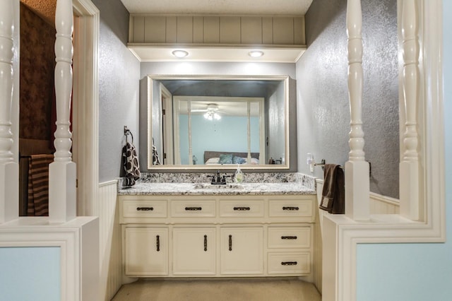 bathroom featuring ceiling fan and vanity