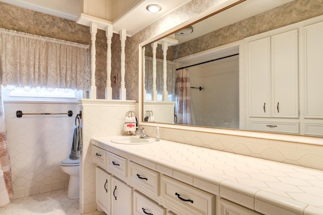 bathroom with tile patterned flooring, vanity, and toilet