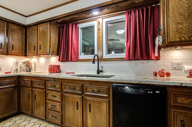 kitchen featuring light stone counters, sink, backsplash, and dishwasher