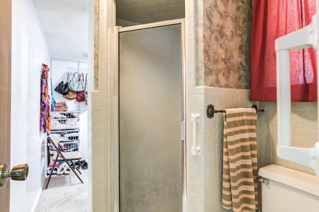 bathroom featuring ornamental molding, toilet, and an enclosed shower