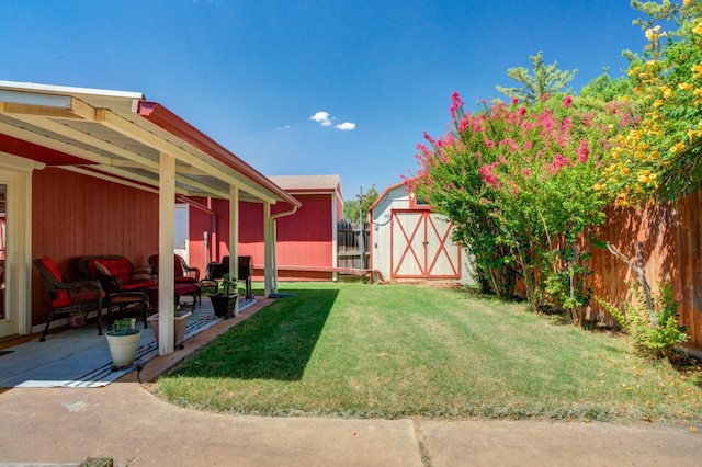 view of yard featuring a storage unit and a patio