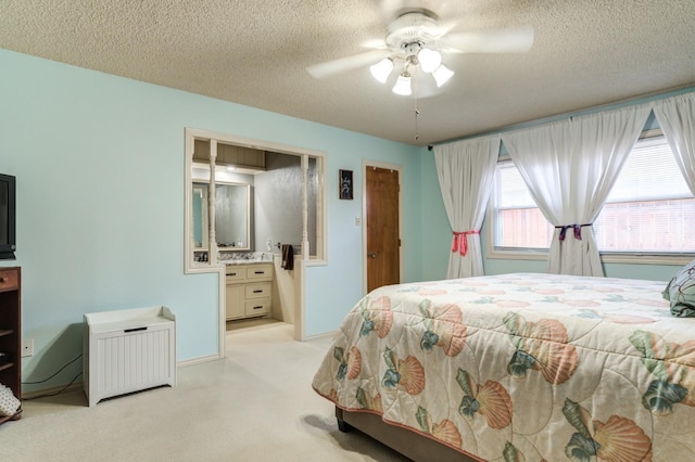 bedroom with connected bathroom, a textured ceiling, and ceiling fan