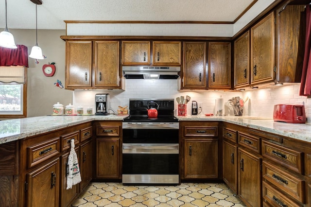 kitchen featuring range with two ovens, pendant lighting, light stone counters, and a textured ceiling