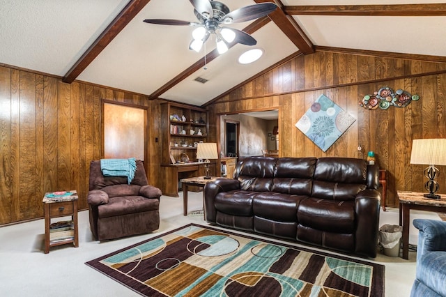 carpeted living room featuring ceiling fan, wooden walls, lofted ceiling with beams, and built in features