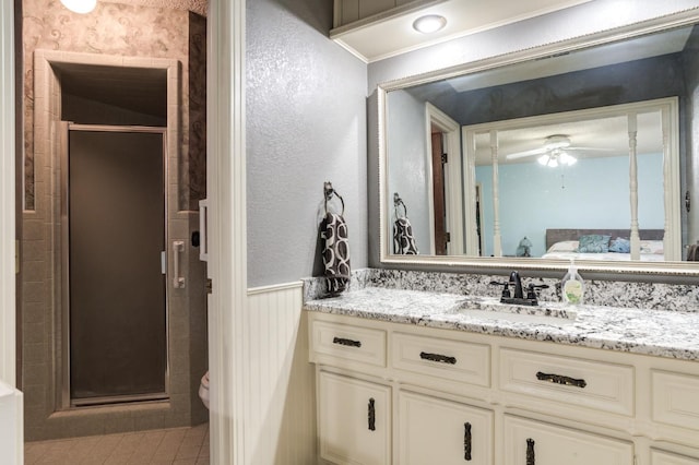 bathroom featuring vaulted ceiling, vanity, walk in shower, ceiling fan, and toilet